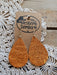 Brown textured teardrop earrings on a 'Western Border' branded card with lace background